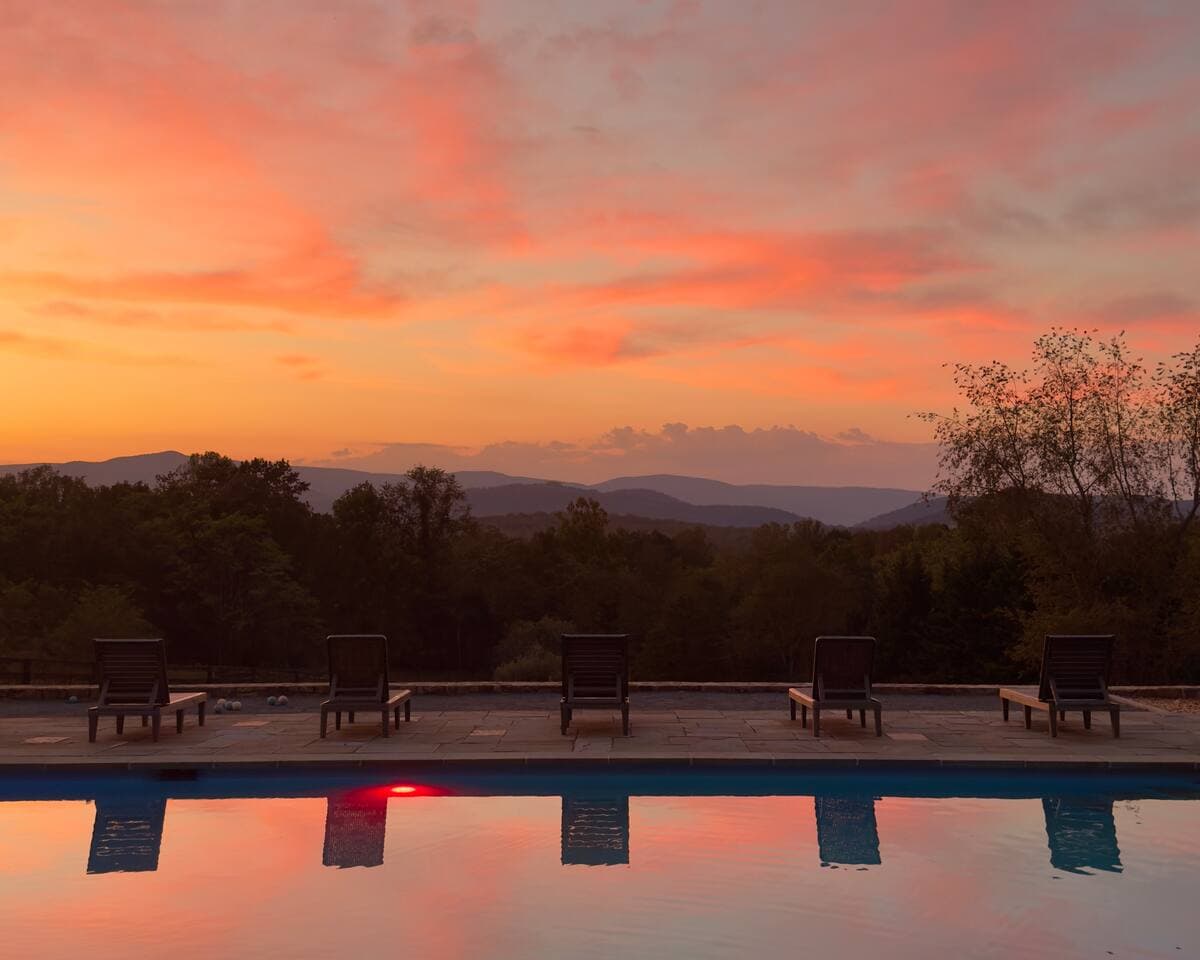 Sunset reflected in the pool with mountain silhouettes
